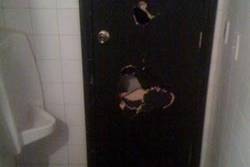 Photograph of the damaged bathroom door from Ben Carver's blog